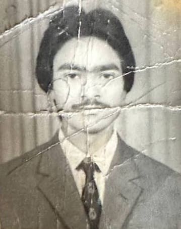 Creased ID photo · phone photo, before restoration